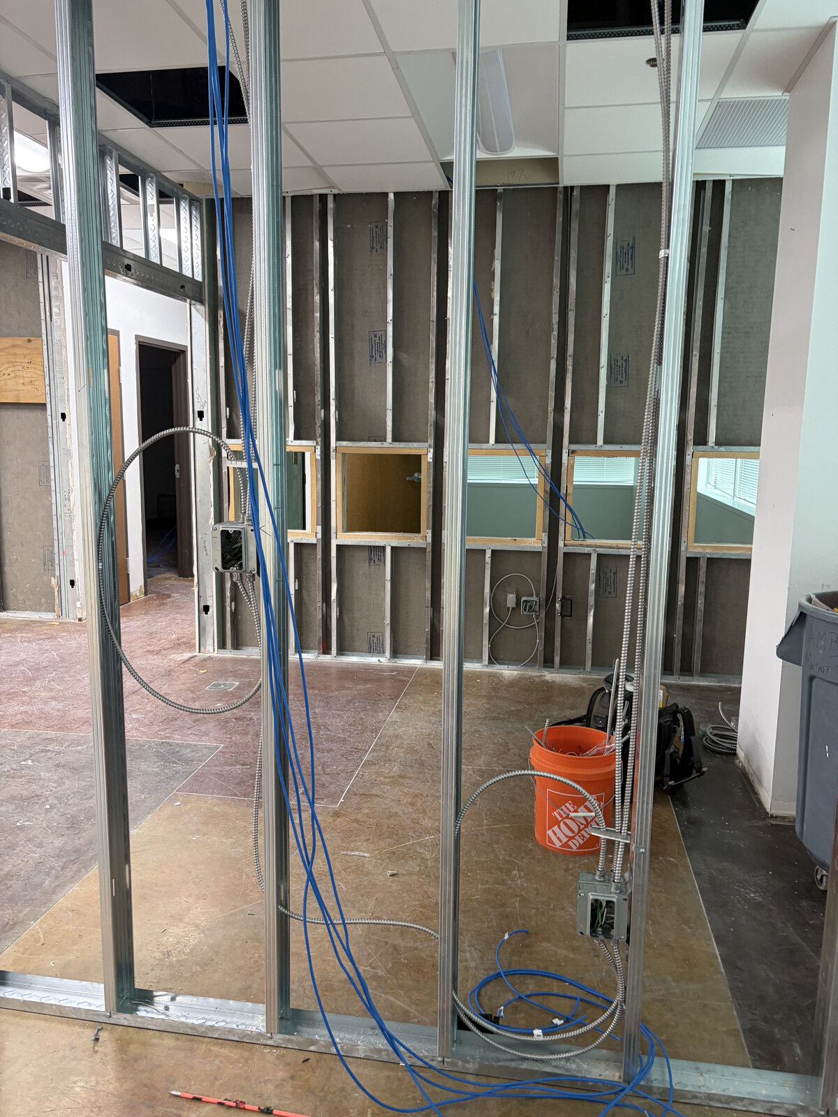 Metal wall framing with electrical boxes and low-voltage cabling in a commercial space
